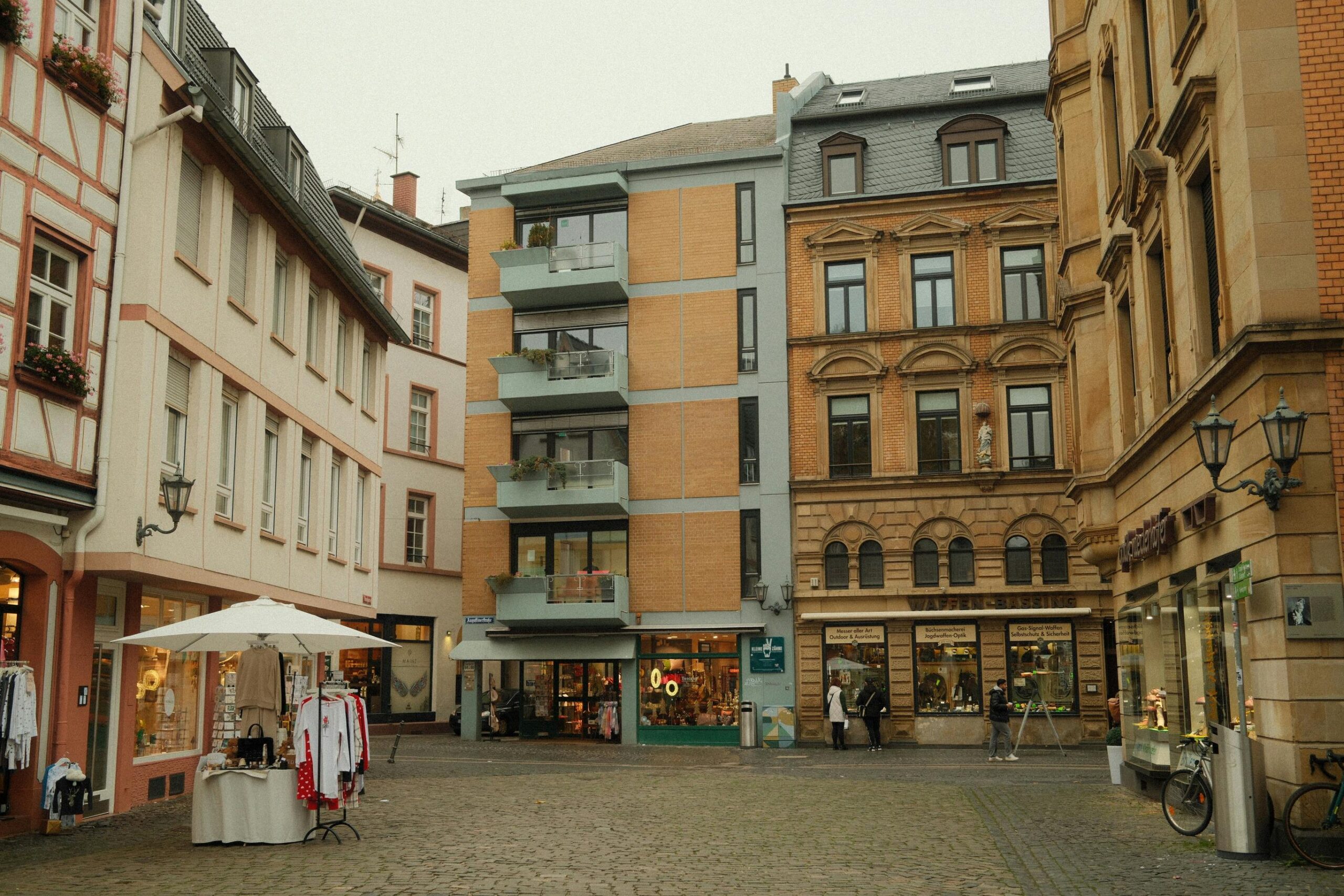 Gem&uuml;tlicher Marktplatz in Mainz, Deutschland, mit reizvoller Fachwerkarchitektur und Freiluftgesch&auml;ften.